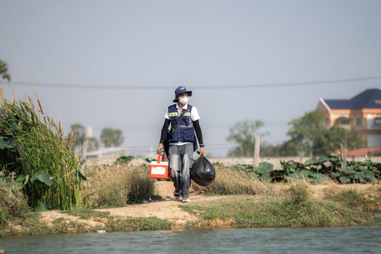 The view of IPC technician collecting water sample.